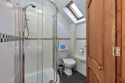 a bathroom with a toilet and a glass shower at Finest Retreats - Helygen in Talybont