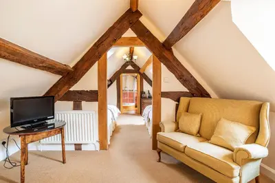 a living room with a couch and a tv at The Town House Ludlow in Ludlow