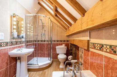 a bathroom with a toilet and a shower and a sink at The Town House Ludlow in Ludlow