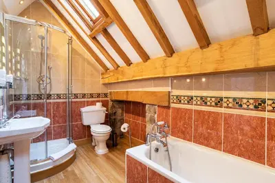 a bathroom with a tub and a toilet and a sink at The Town House Ludlow in Ludlow