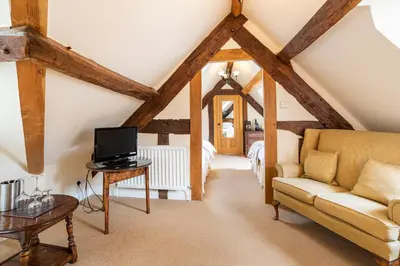 a living room with a couch and a tv at The Town House Ludlow in Ludlow
