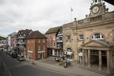 a city street with buildings and a clock tower at The Town House Ludlow in Ludlow