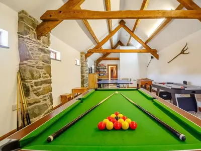 a pool table with balls on it in a room at 2 Bed in Dyffryn Ardudwy oc-89394 in Dyffryn