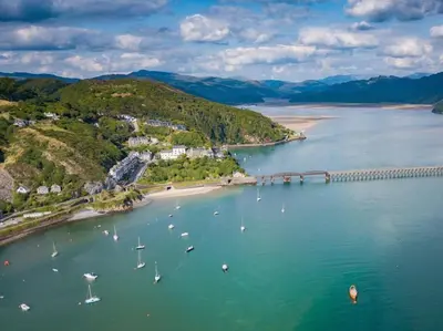 an aerial view of a river with boats and a bridge at 2 Bed in Dyffryn Ardudwy oc-89394 in Dyffryn