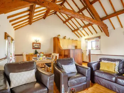 a living room with leather chairs and a table at 2 Bed in Dyffryn Ardudwy oc-89394 in Dyffryn