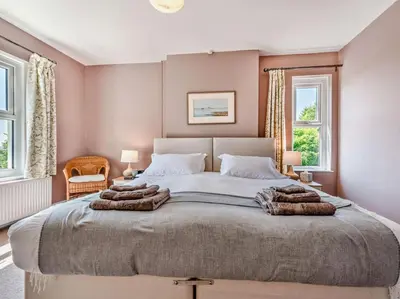 a bedroom with a large bed with towels on it at 3 Bed in Carmarthen oc-92116 in Rhyd-cymmerau