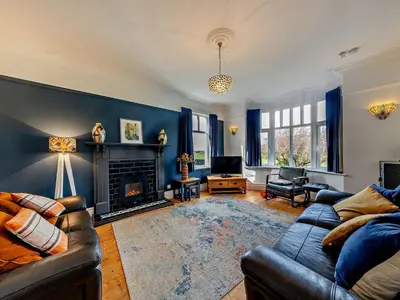 a living room with a couch and a fireplace at 4 Bed in Friog 42772 in Fairbourne