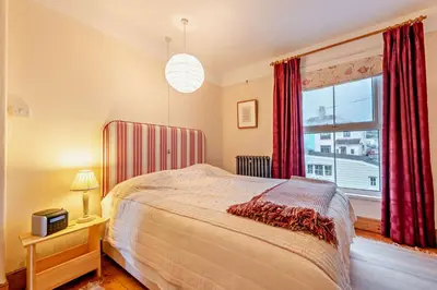 a bedroom with a bed and a large window at 3 Bed in Aberaeron oc-b27954 in Aberaeron