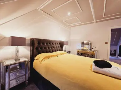 a bedroom with a large bed and a coffered ceiling at Unique town centre apartment with vaulted ceiling - Pass the Keys in Shrewsbury