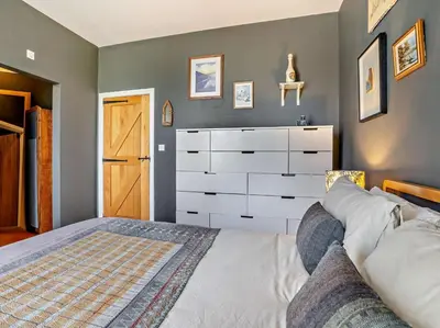 a bedroom with a large bed and a dresser at 4 Bed in Hereford oc-80464 in Glasbury