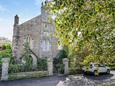 a car parked in front of an old stone church at 4 Bed in Hereford oc-80464 in Glasbury
