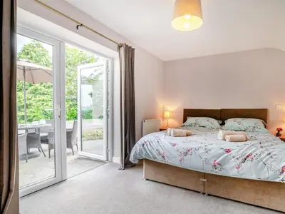 a bedroom with a bed and a sliding glass door at 2 Bed in Llangammarch Wells oc-bn059 in Garth