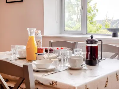 a table with dishes and a coffee maker on it at 2 Bed in Llangammarch Wells oc-bn059 in Garth