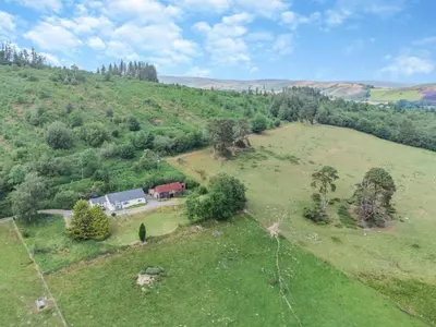 an aerial view of a house on a green field at 2 Bed in Llangammarch Wells oc-bn059 in Garth