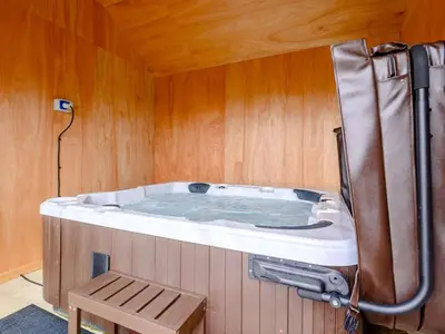 a hot tub in a room with a wooden wall at 2 Bed in Llandrindod Wells oc-89063 in Nantmel