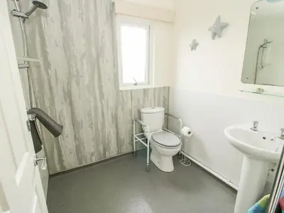 a bathroom with a toilet and a sink at Dragonfly Lodge in Shrewsbury