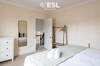 a bedroom with a bed with two pillows on it at 4 Bedroom House. Close to Shrewsbury Town Centre in Shrewsbury