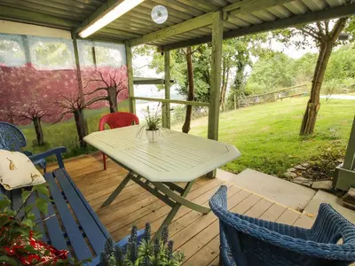 a patio with a table and chairs on a deck at The Pod in Shrewsbury
