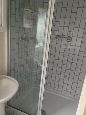 a bathroom with a shower and a sink at H2 in Aberystwyth