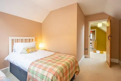 a small bedroom with a bed and a hallway at Waun Yscir Rural escape in the Brecon Beacons in Brecon