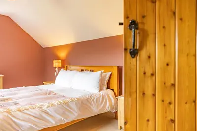 a bedroom with a large bed and a closet at Waun Yscir Rural escape in the Brecon Beacons in Brecon