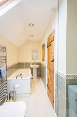 a bathroom with a tub and a sink at Waun Yscir Rural escape in the Brecon Beacons in Brecon