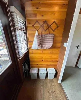 a bathroom with two toilets and a basket on the wall at Snug and cosy log cabin. in Trawsfynydd