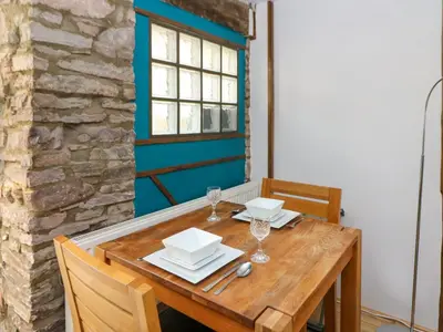 a wooden table with plates and glasses on it at Rhif Deg in Brecon