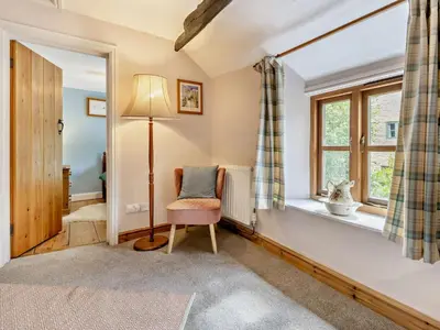 a room with a chair and a window at 3 Bed in Clyro 88077 in Clyro