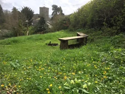 a wooden bench sitting in a field of flowers at 3 Bed in Clyro 88077 in Clyro