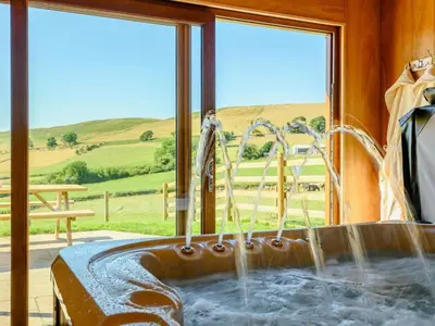 a bathroom with a tub with a water fountain at 2 Bed in Llandrindod Wells oc-89064 in Nantmel
