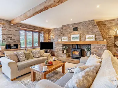 a living room with a stone wall at 3 Bed in Brecon oc-bn430 in Llangorse