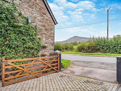 an entrance to a brick building with a wooden gate at 3 Bed in Brecon oc-bn430 in Llangorse