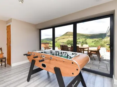 a pool table in a room with a large window at 4 Bed in Oswestry oc-87477 in Llansilin