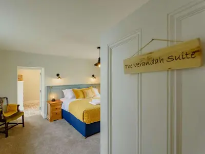 a bedroom with a bed and a sign that reads the wandholm suite at 4 Bed in Oswestry oc-87477 in Llansilin