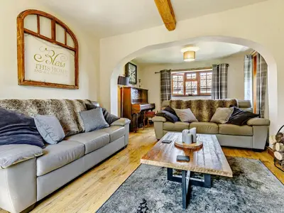 a living room with two couches and a table at 4 Bed in Hereford oc-44213 in Hereford