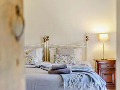 a bedroom with a white bed with blue blankets and pillows at 4 Bed in Hereford oc-44213 in Hereford