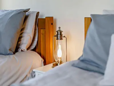a lamp sitting on a table next to two beds at 4 Bed in Hereford oc-44213 in Hereford