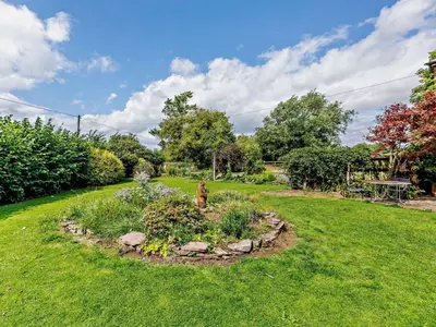 a garden with a fire hydrant in the middle of a yard at 4 Bed in Hereford oc-44213 in Hereford