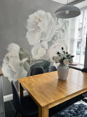 a dining room table with a vase of flowers on a wall at Isfryn, holiday home in Aberdyfi in Aberdyfi