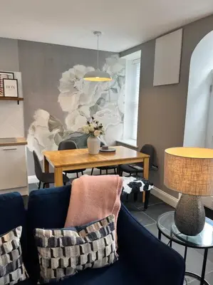 a living room with a table and chairs and a dining room at Isfryn, holiday home in Aberdyfi in Aberdyfi