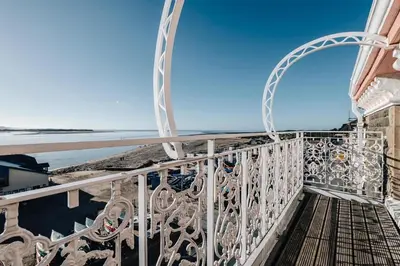 a balcony with a view of the ocean at The Penthouse Westhaven Aberdyfi in Aberdyfi