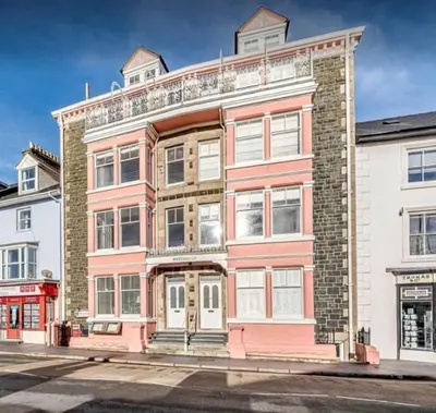 an apartment building on the corner of a street at The Penthouse Westhaven Aberdyfi in Aberdyfi