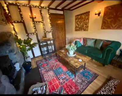 a living room with a green couch and a coffee table at Maytree Cottage. Compact home in Mid Wales. in Llanrhaeadr-ym-Mochnant