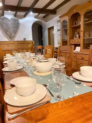a table with plates and bowls and glasses on it at Quarry House in Presteigne