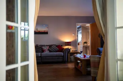 a living room with a couch and a table at Quarry House in Presteigne