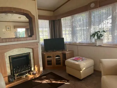 a living room with a fireplace and a television at Heavenly Retreat in Lampeter