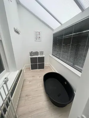 a room with a large black tub in the middle of a room at Polruan - stunning central NQ house - dog friendly in New Quay
