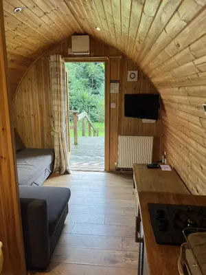 a small room with a bed and a tv in a room at Mountain Edge Resort Mega pod 2 with Hot Tub in Church Stretton