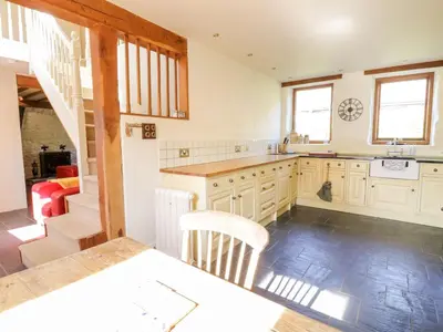 a kitchen with a sink and a counter top at Pandy Farmhouse - Panoramic mountain views within Snowdonia's National Park - 4x4 Only in Dolgellau